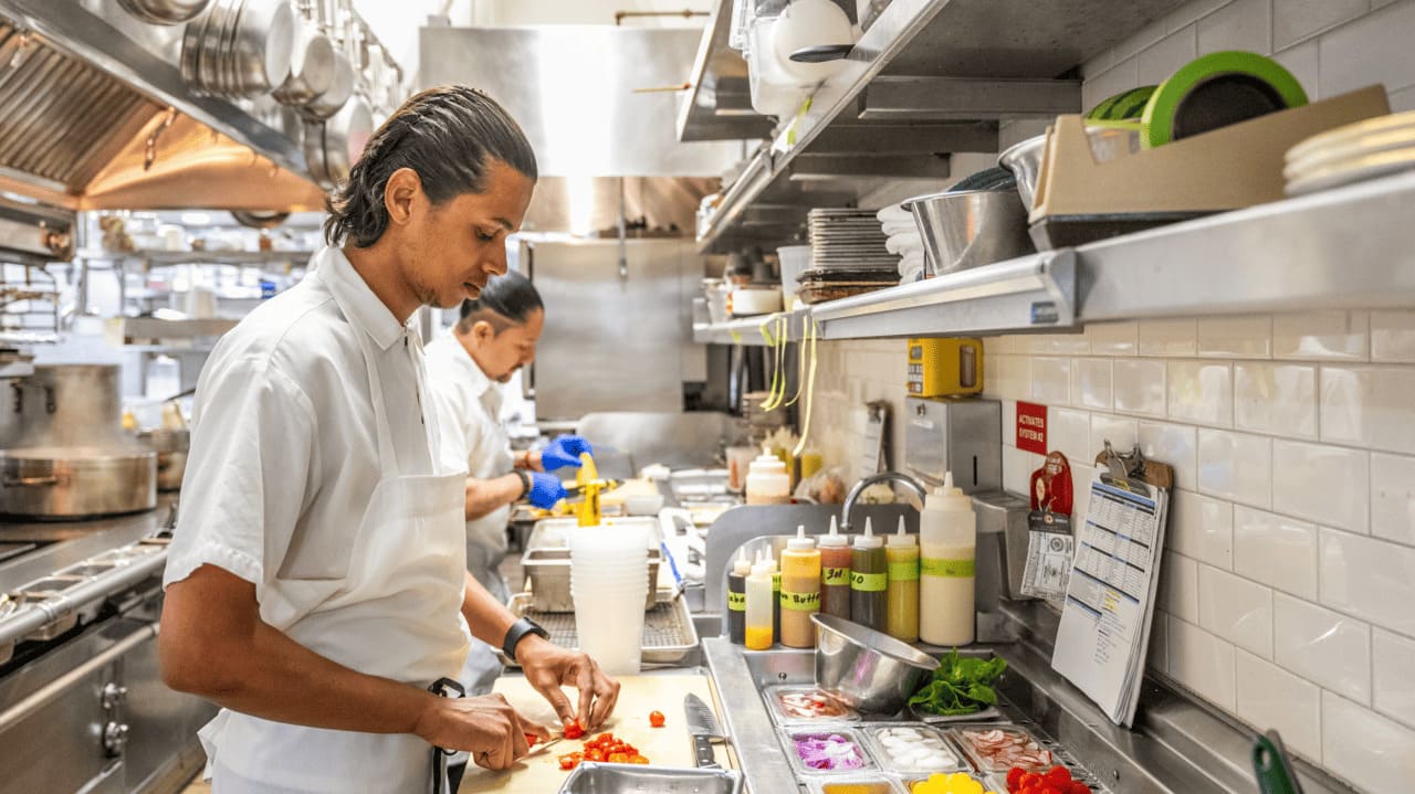 Chef Sarvesh Naik preparing food in a restaurant kitchen
